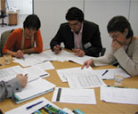 People around a table covered in papers